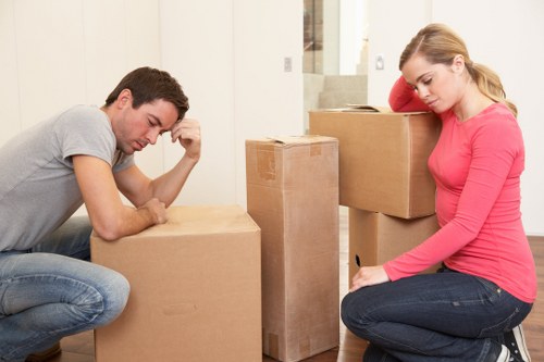 Removal team carrying furniture through a Dulwich home